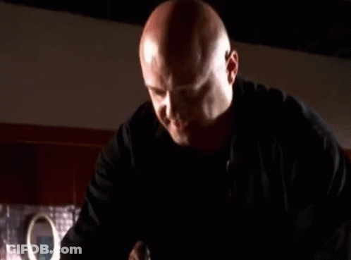 Man In Black Jacket Holding Gun GIF