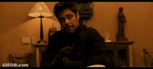 Man In Black Jacket Holding Gun In Dark Room GIF