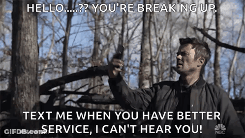 Man In Black Jacket Holding Gun In Forest Saying Hello You're Breaking Up GIF