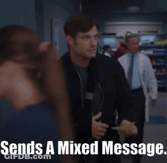 Man In Black Jacket Holding Paper Says Sends A Mixed Message GIF