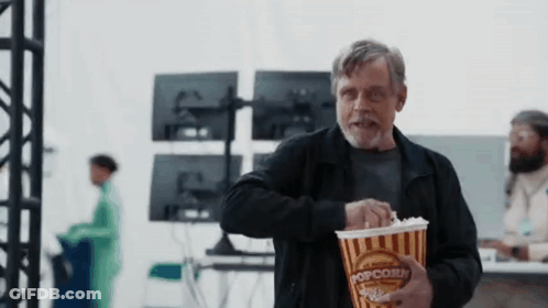 Man In Black Jacket Holding Popcorn GIF
