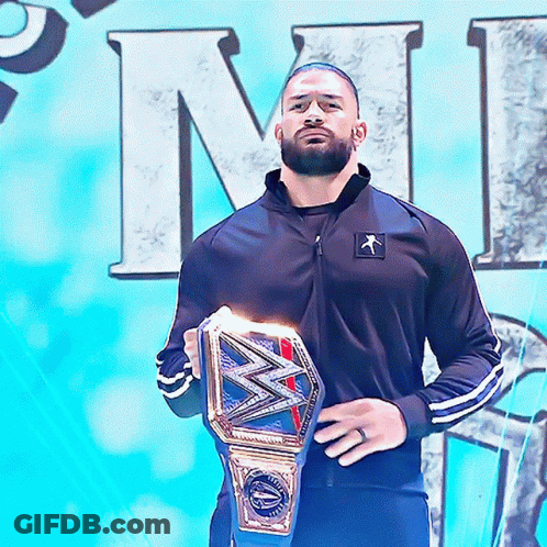 Man In Black Jacket Holding Wrestling Belt GIF