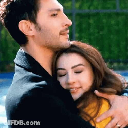 Man In Black Jacket Hugging Woman With Eyes Closed GIF