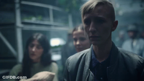 Man In Black Jacket In Crowd GIF