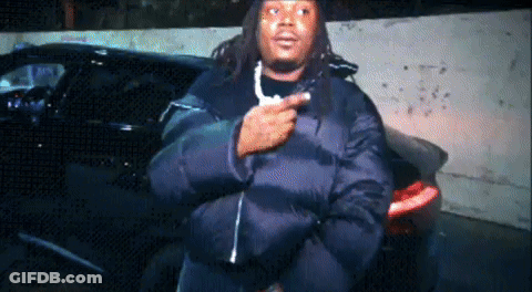 Man In Black Jacket In Front Of Cars GIF