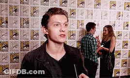 Man In Black Jacket In Front Of Comic Book Wall GIF