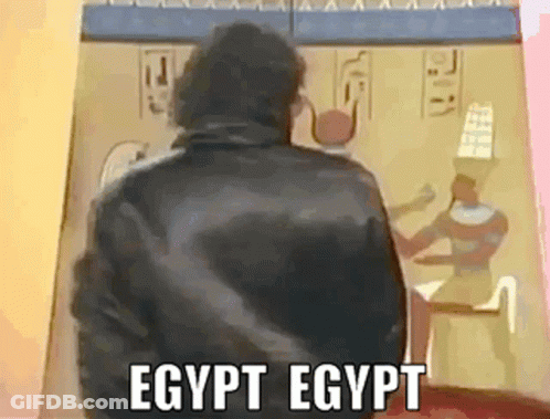 Man In Black Jacket In Front Of Egyptian Painting GIF