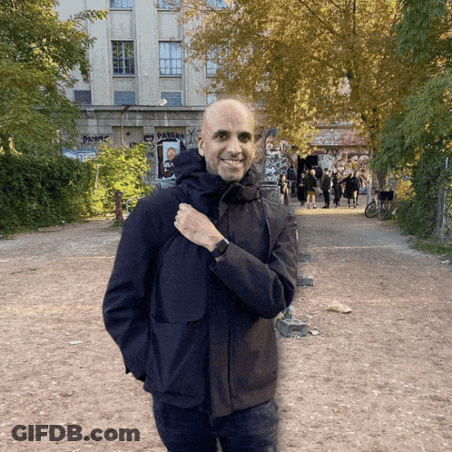 Man In Black Jacket In Front Of Paranoia Graffiti GIF