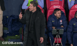 Man In Black Jacket In Front Of Red Seats Saying Digi GIF