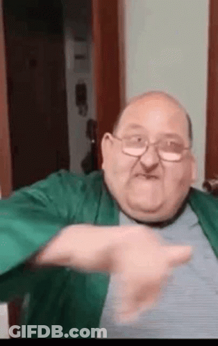 Man In Black Jacket In Front Of Red Seats Saying Digi GIF