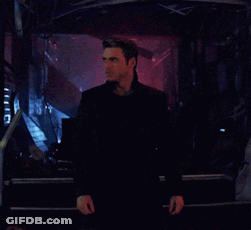 Man In Black Jacket In Front Of Screen GIF