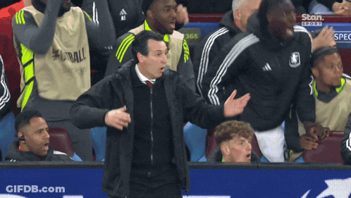 Man In Black Jacket In Front Of Stour Sports Sign GIF