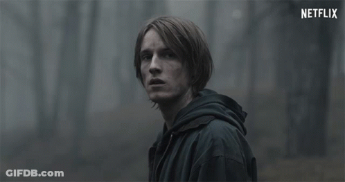 Man In Black Jacket Looking At Netflix Logo GIF