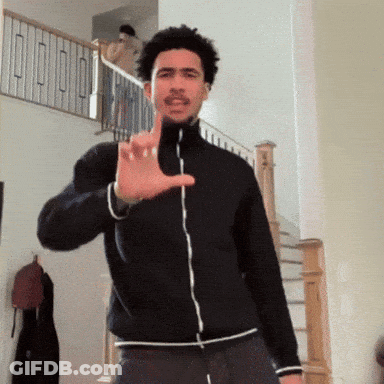 Man In Black Jacket Making Hand Gesture GIF