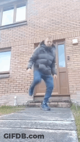 Man In Black Jacket Running Down Stairs GIF