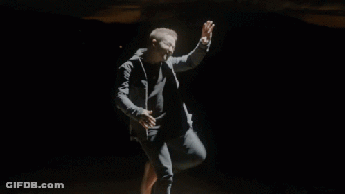 Man In Black Jacket Running Through Smokey Area GIF
