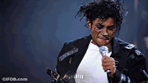 Man In Black Jacket Singing Into Microphone What GIF