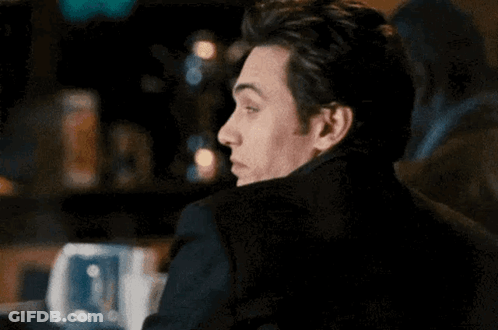 Man In Black Jacket Sitting At Table GIF