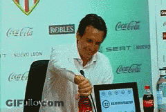 Man In Black Jacket Sitting In White Cushion Chair GIF