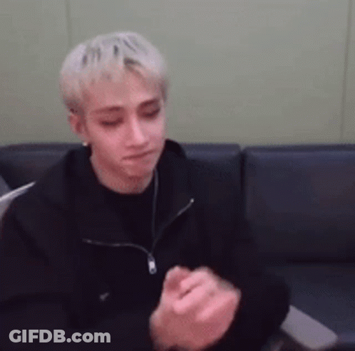 Man In Black Jacket Sitting On Couch With Hands Folded GIF