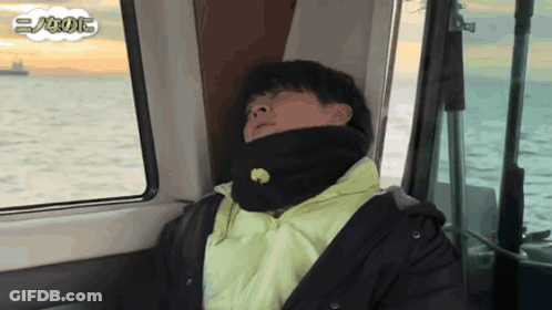 Man In Black Jacket Sleeping On Boat In Ocean GIF