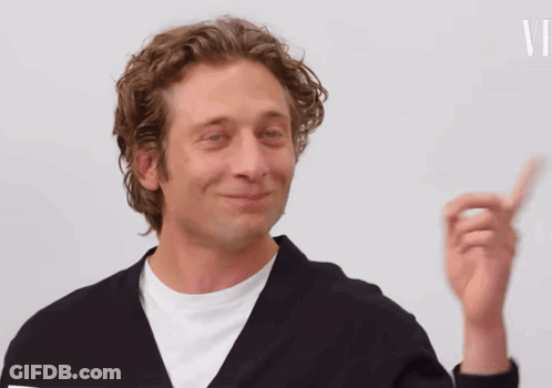 Man In Black Jacket Smiling And Pointing Up GIF