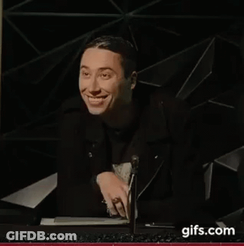 Man In Black Jacket Smiling At Microphone GIF