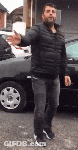 Man In Black Jacket Smoking Cigarette GIF