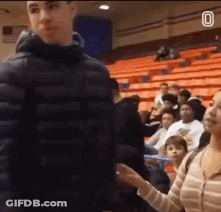 Man In Black Jacket Standing Before Crowd In Auditorium GIF