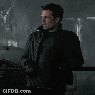 Man In Black Jacket Standing In Dark Room With Eyes Closed GIF