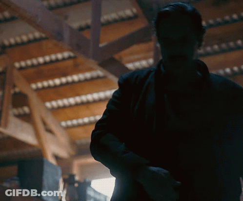 Man In Black Jacket Standing In Dark Room GIF