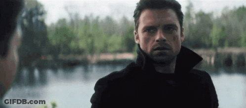 Man In Black Jacket Standing In Front Of Lake GIF
