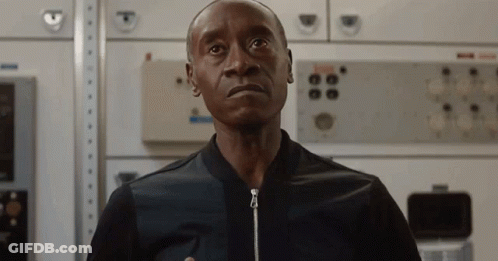 Man In Black Jacket Standing In Front Of Wall With Buttons GIF