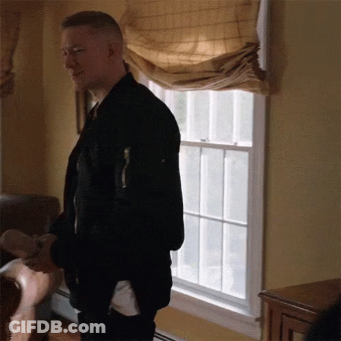 Man In Black Jacket Standing In Front Of Window GIF