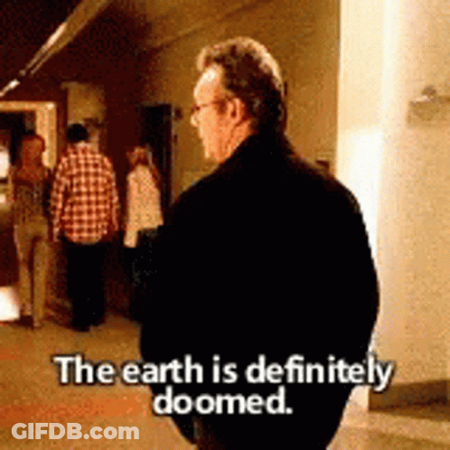 Man In Black Jacket Standing In Hallway Says The Earth Is Definitely Doomed GIF