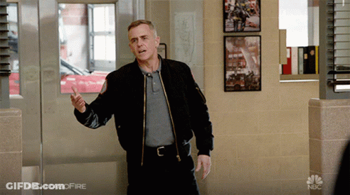 Man In Black Jacket Standing In Hallway With #Chicagofire GIF