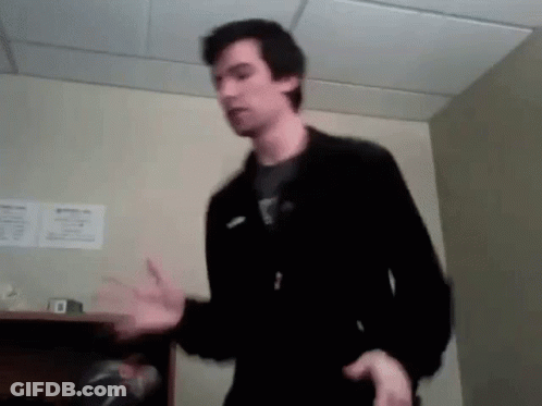 Man In Black Jacket Standing In Room GIF