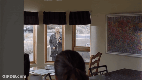 Man In Black Jacket Standing In Window GIF