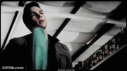 Man In Black Jacket Standing Near Glass Shelf GIF