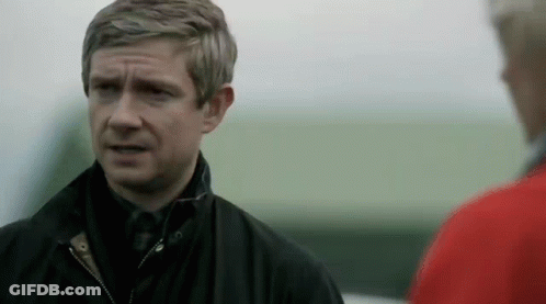 Man In Black Jacket Standing Next To Man In Red Jacket GIF