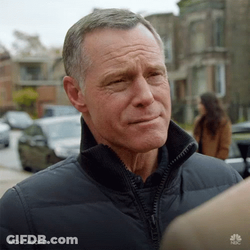Man In Black Jacket Talking To Another Man With Woman In Background GIF