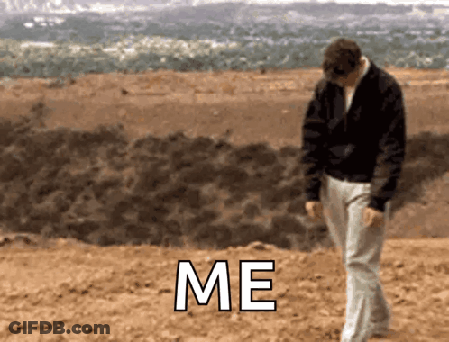 Man In Black Jacket Walking In Dirt Saying Me GIF