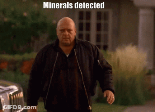 Man In Black Jacket Walking In Front Of Car Saying Minerals Detected GIF