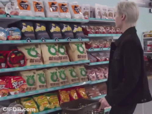 Man In Black Jacket With Basket Of Snacks GIF