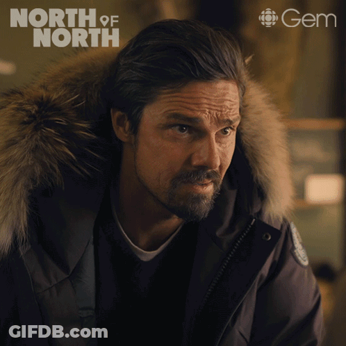 Man In Black Jacket With Fur Hood And Gem Logo GIF