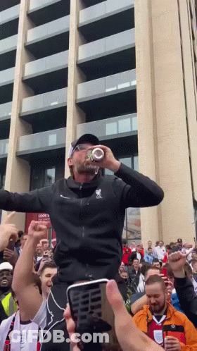 Man In Black Jacket With Letter L Drinking From Bottle GIF