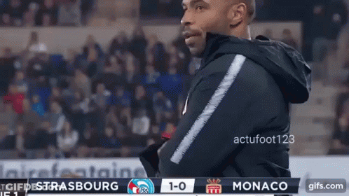 Man In Black Jacket With Monaco 1-0 Scoreboard GIF