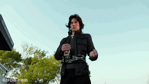 Man In Black Jacket With Red Button R GIF