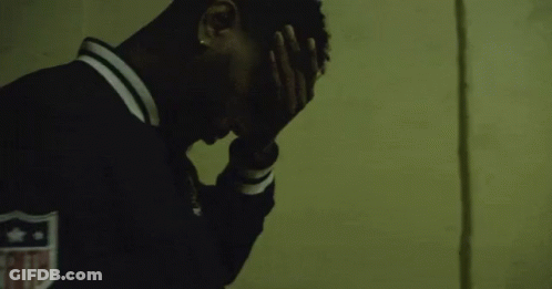 Man In Black Jacket With Shield Covering Face GIF