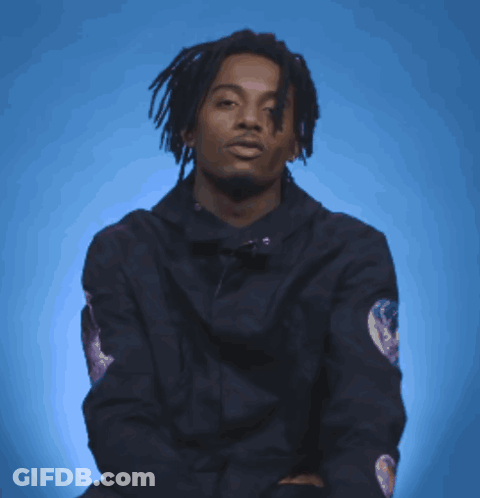 Man In Black Jacket With Sleeve Patch Pointing GIF